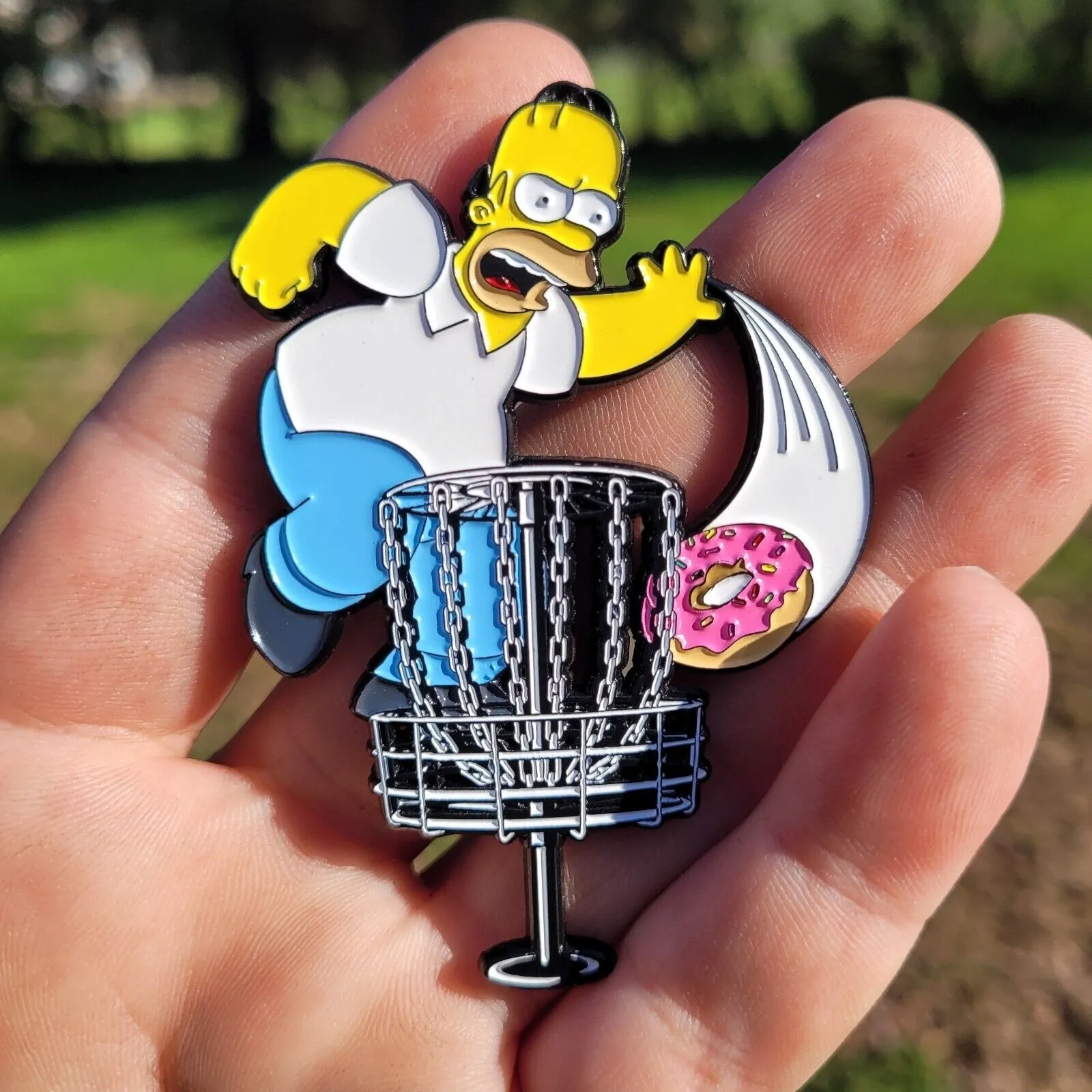 A person holding a frisbee with a simpsons character on it.