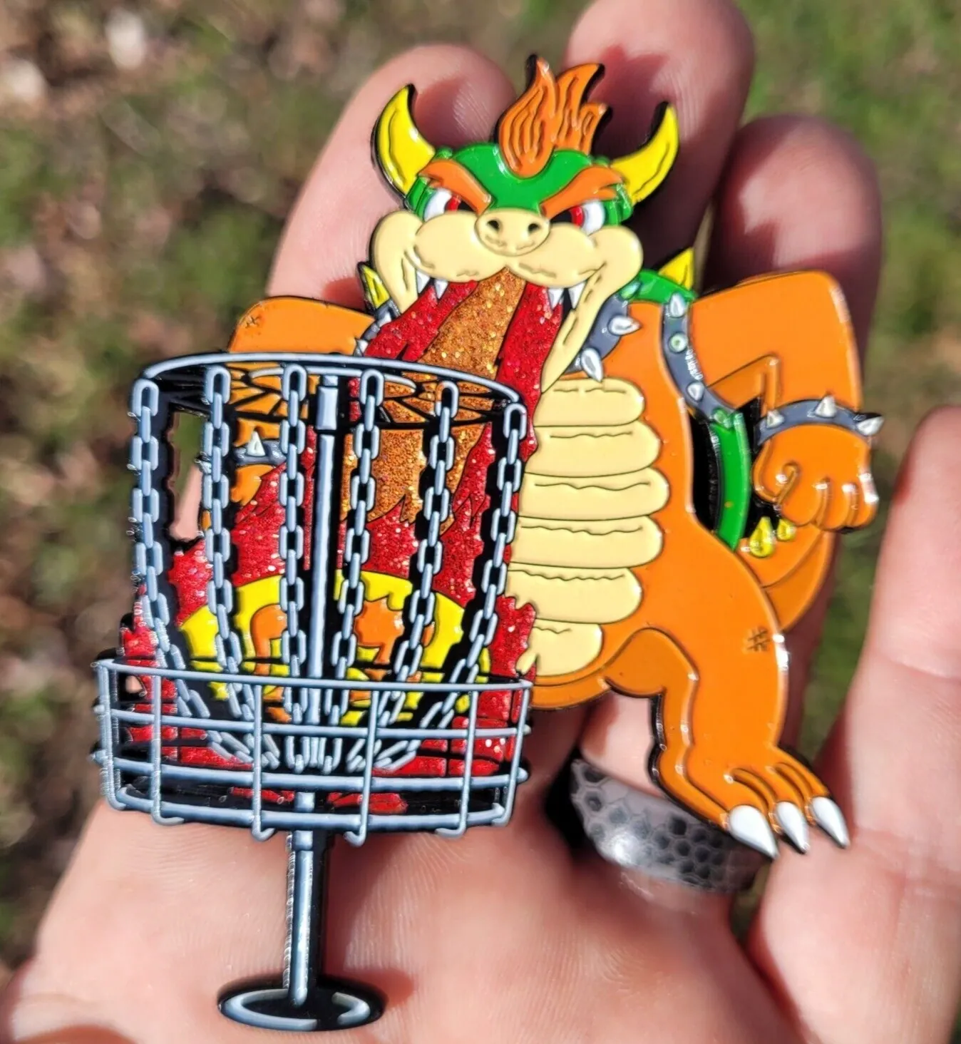 A person holding a pin with a bowser in it
