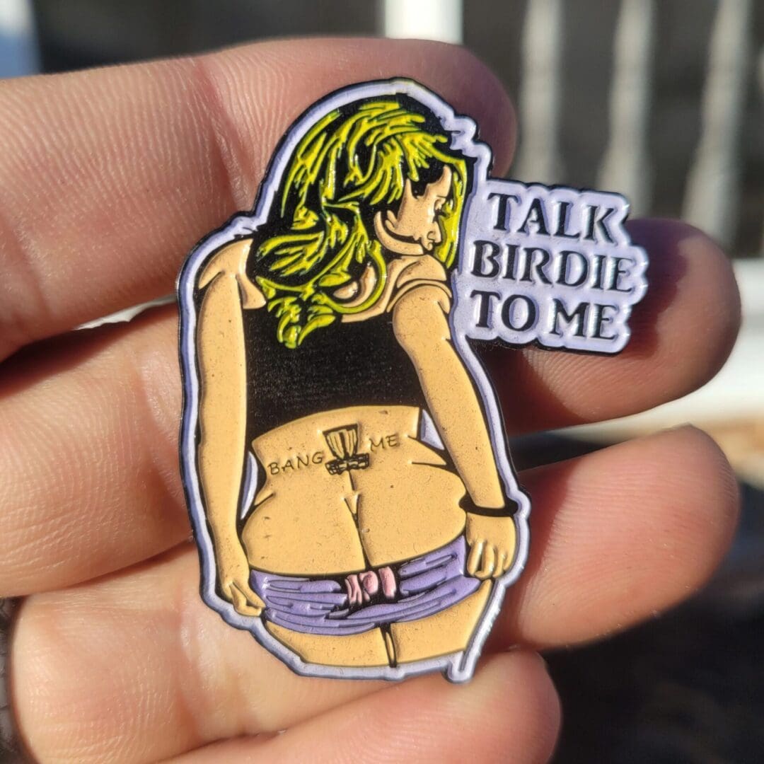 A person holding up a sticker with a woman 's butt.