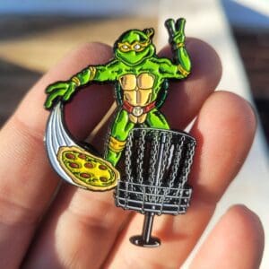 A person holding a pin with a turtle on it